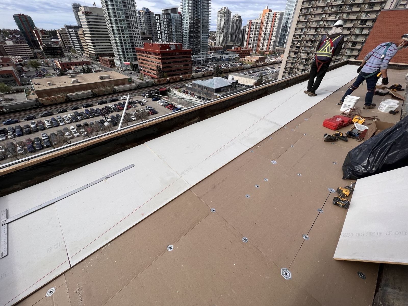 Crew installing a roof on a downtown building