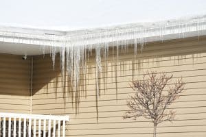 Row of icicles from the roof of the house.