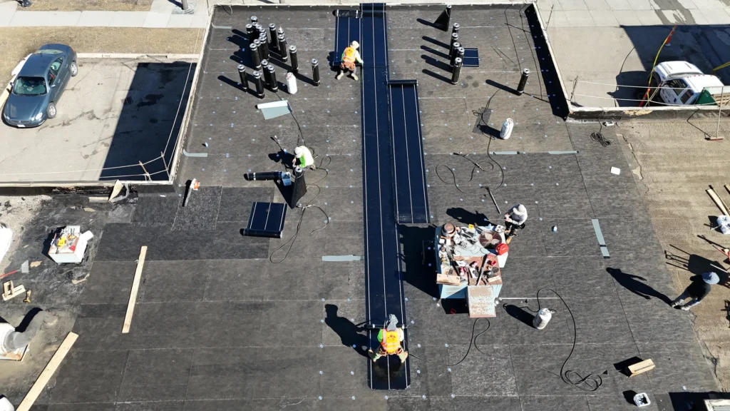 Aerial view of a roofing crew installing a new roof