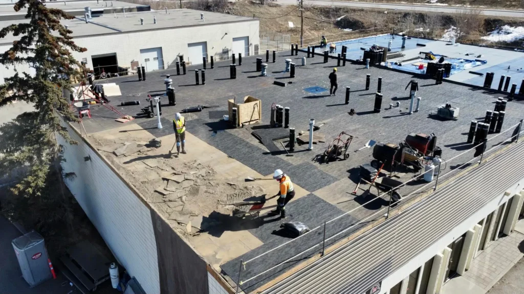 Aerial view of a roofing crew working on a roof during a tear-off