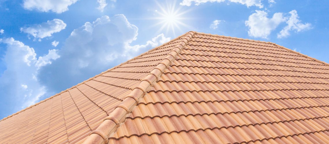 Roof tiles and sky sunlight. Roofing Contractors concept Installing House roof.