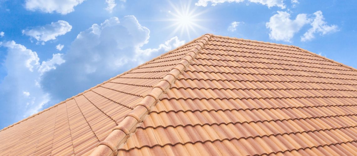 Roof tiles and sky sunlight. Roofing Contractors concept Installing House roof.